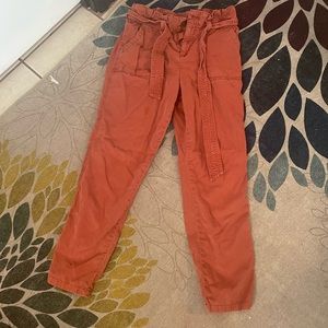 Rust colored pants with zipper one button and tie.